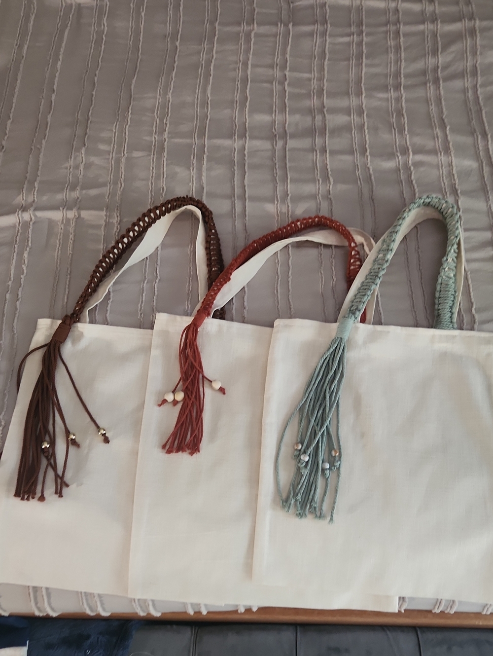 White Canvas Tote with Braided Tassel Handles - Brown, Rust, and Pale Blue.